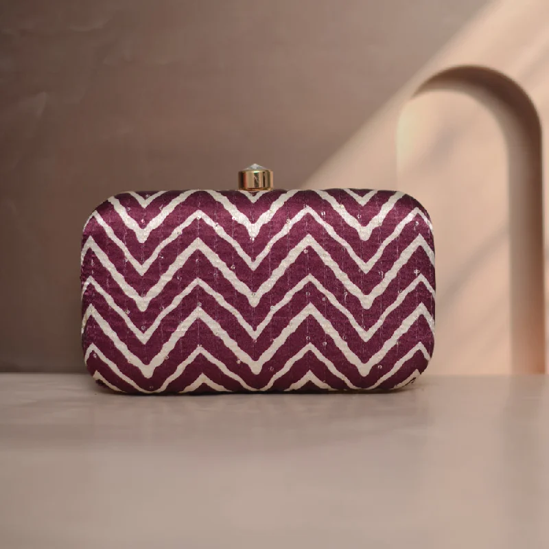 Velvet clutch with a tassel detail for a bohemian - chic styleArtklim  Maroon And White Zigzag Printed Clutch