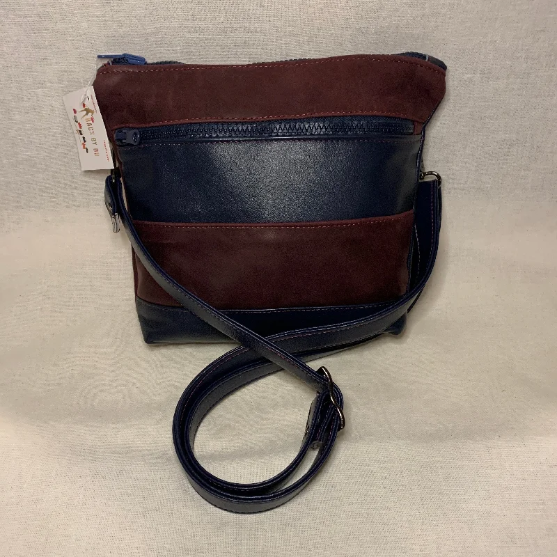 Vegan leather crossbody bag for eco - conscious consumersClassically designed all leather crossbody bag with burgundy and navy stripes.