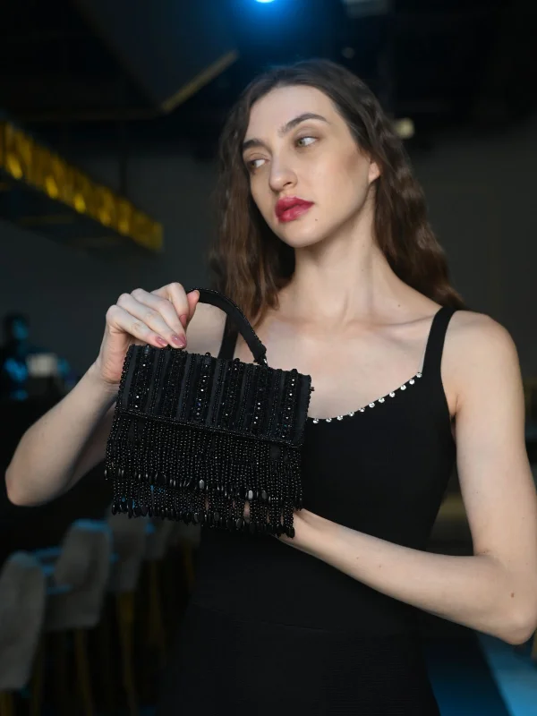 Women's satin clutch with a beaded flower accent for a glamorous eveningOdette Black Embellished Clutch With Tassels For Women