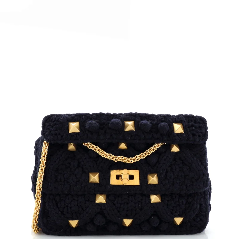 Faux fur satchel with a fluffy exterior for a winter fashion statementRoman Stud Flap Bag Knit Crochet Large